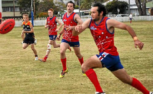 Redbacks player Tony Chandler sprints to the ball. Redbacks player Tony Chandler sprints to the ball.